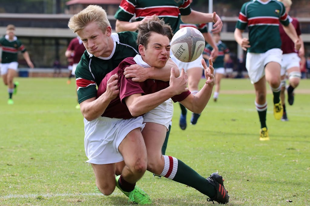 Rugby players in action during a tackle, showing concussions in rugby matches