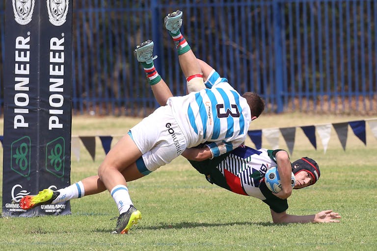 Rugby players mid-tackle during a competitive match